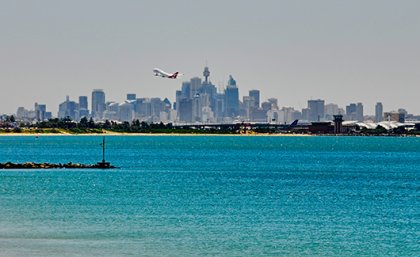 A plane taking-off over water.